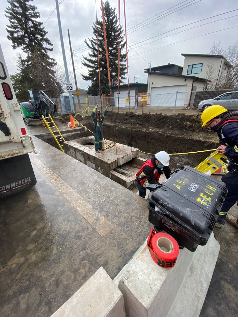 ASI Tech crew installing a precast vault on a residential street