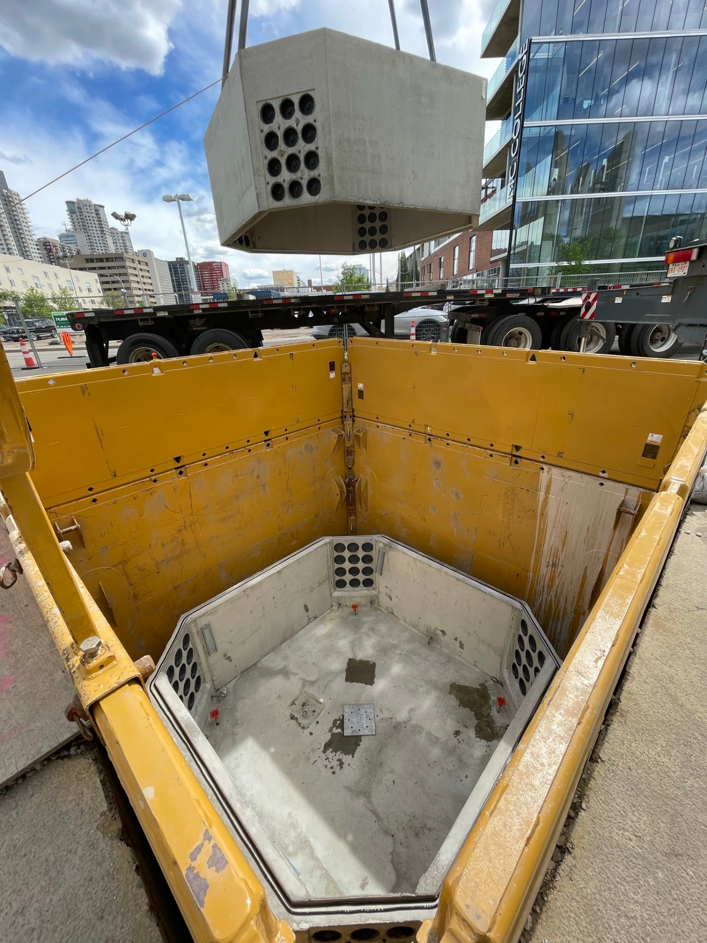 Precast communication vault being lowered into place