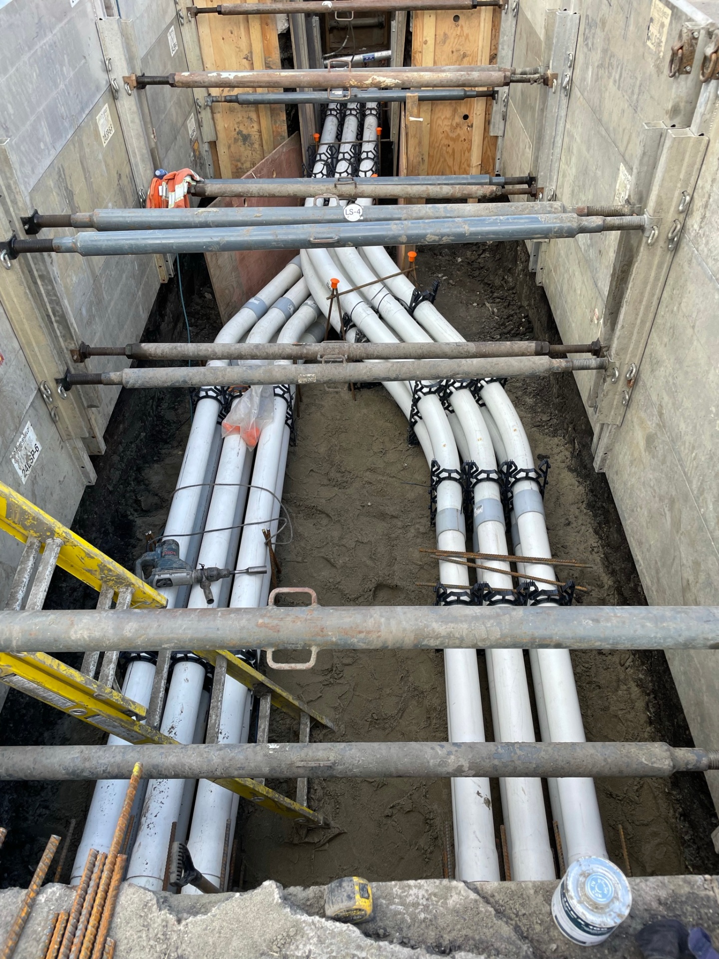 Crossing PVC conduit banks with spacers inside shored trench excavation