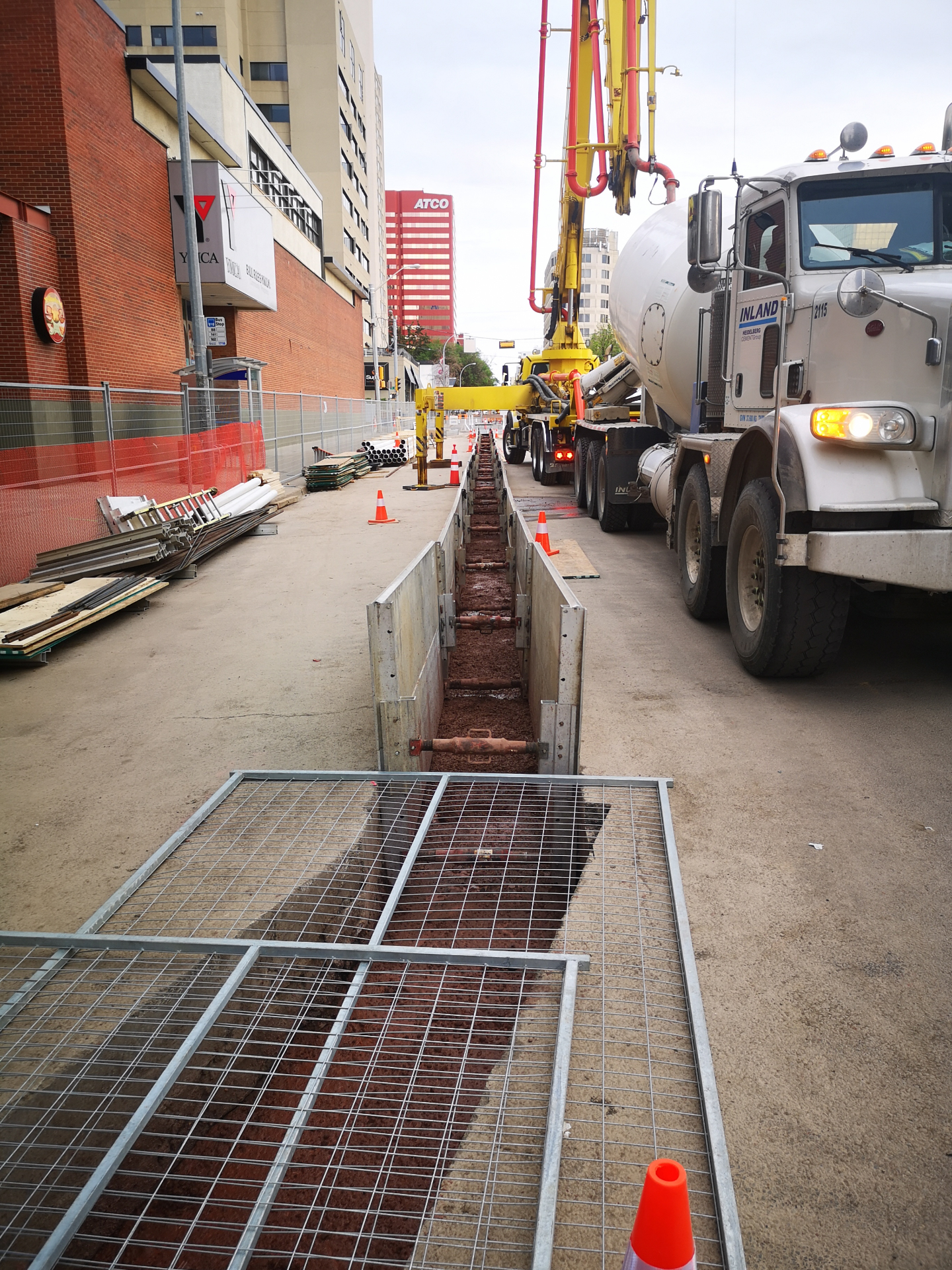 Concrete pour into shored ductbank trench with concrete pump truck
