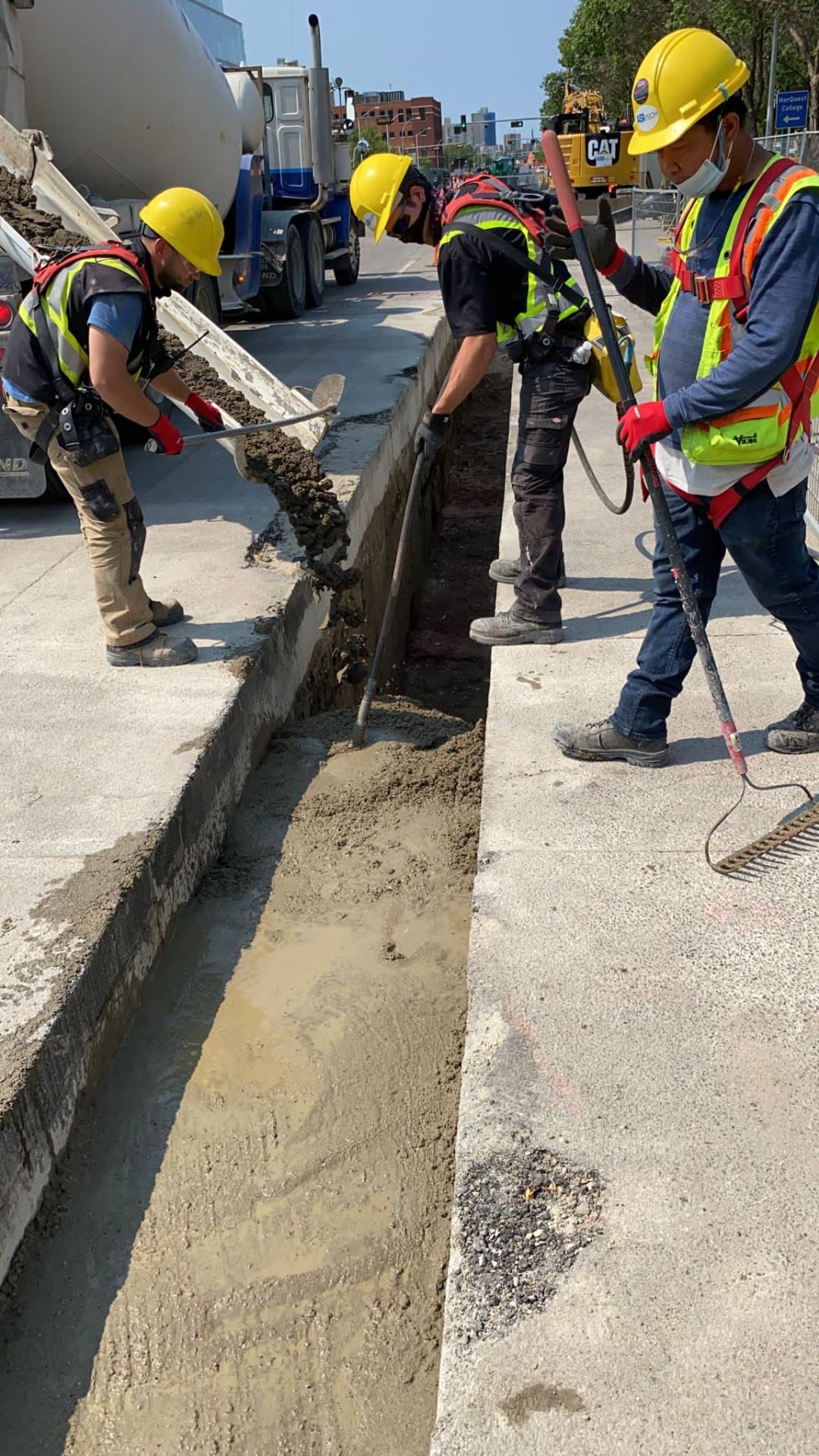 Crew placing and vibrating concrete encasement around duct bank