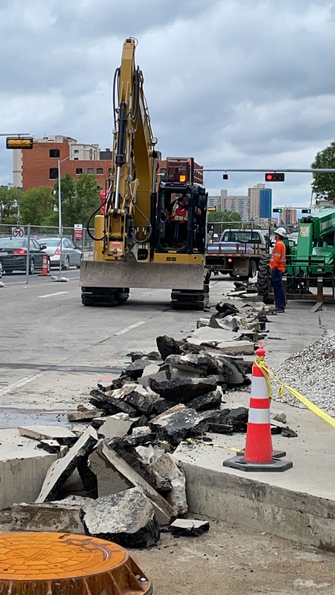 Excavator removing concrete pavement for ductbank installation