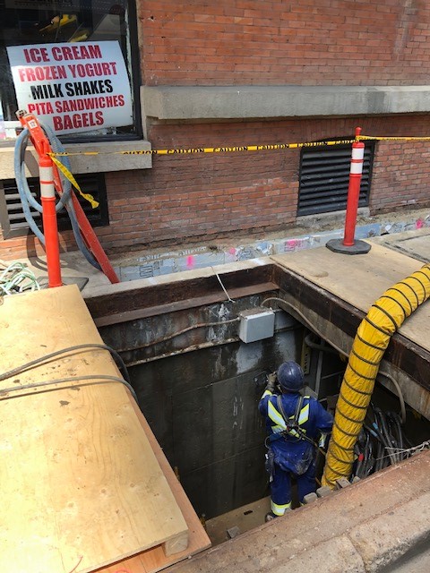 ASI Tech crew working in shored underground vault excavation in downtown street