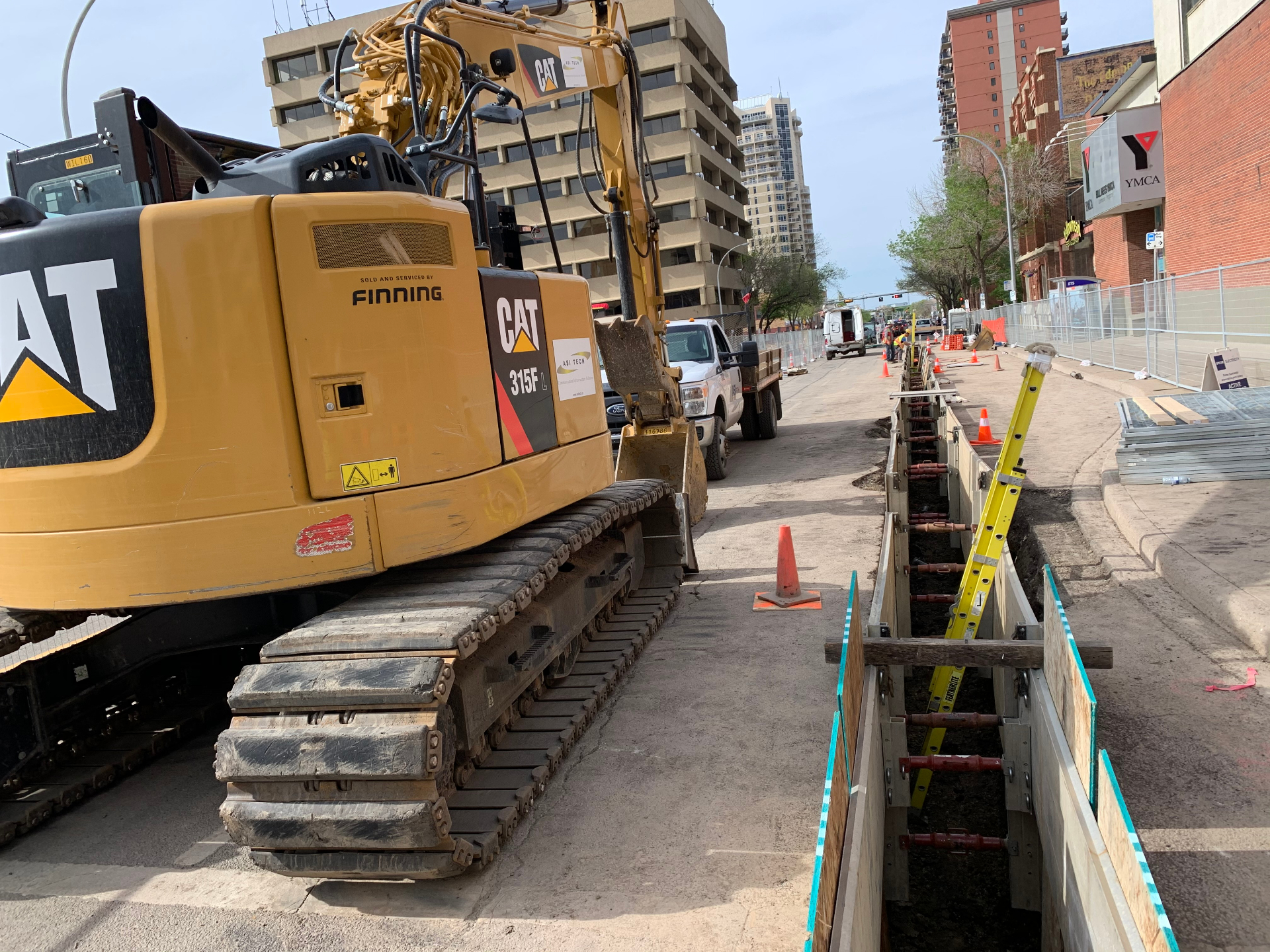 ASI Tech CAT 315F excavator on downtown ductbank installation site