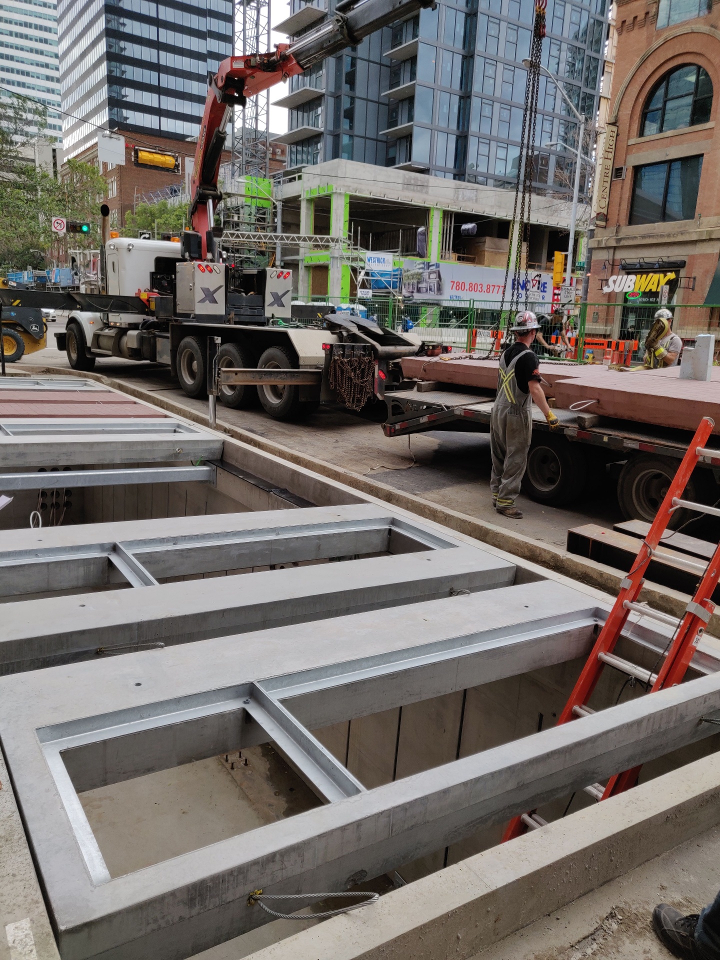 Precast concrete vault placement with picker truck on downtown Edmonton street