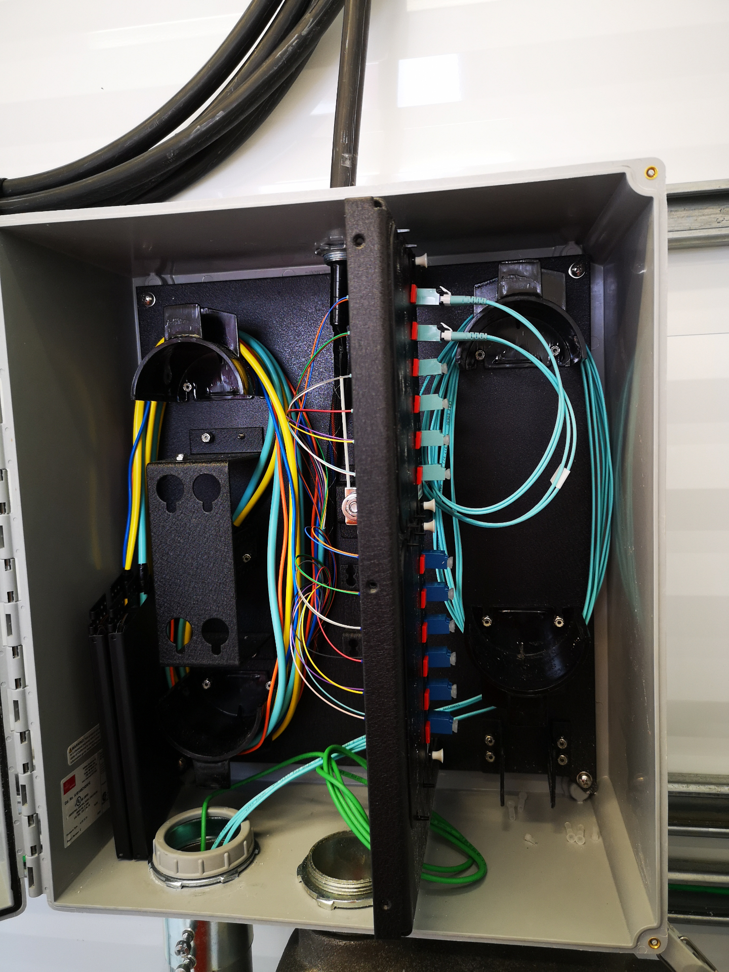 Fiber termination enclosure with patch panel and splice tray