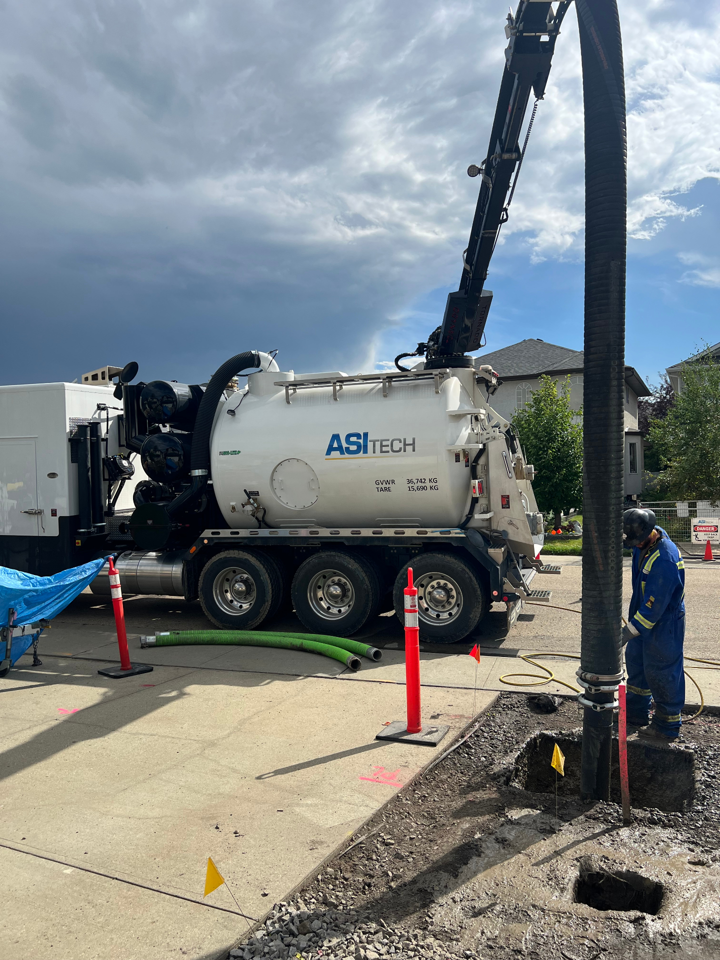 ASI Tech hydrovac truck performing daylighting excavation in residential neighborhood