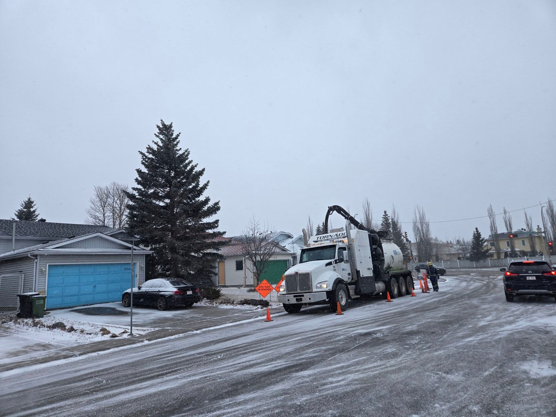 ASI Tech hydrovac truck working in snowy winter street conditions